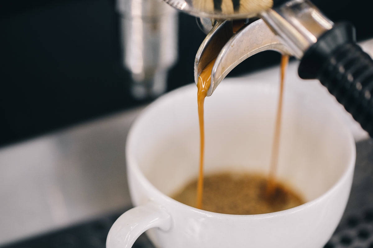 Close-up of espresso pouring from a professional coffee machine